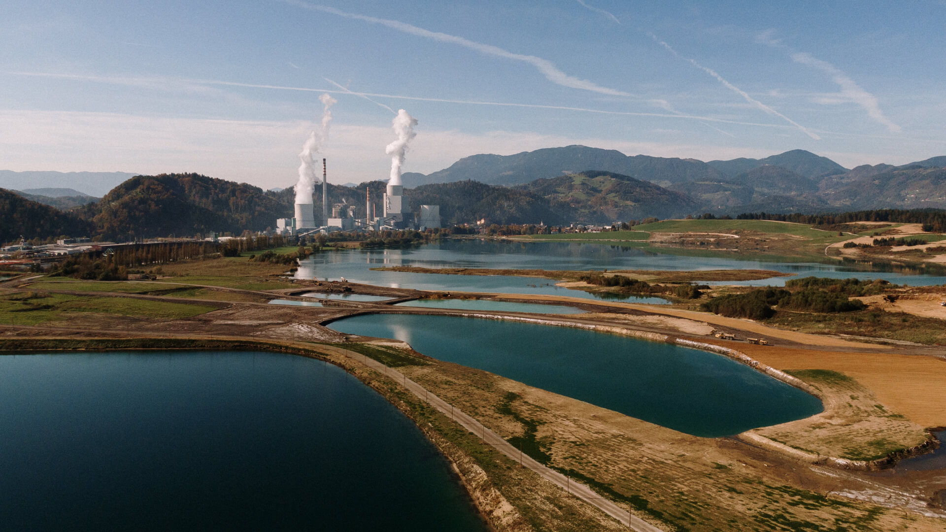 aerial-shot-landscape-surrounded-by-mountains-lakes-with-industrial-disaster